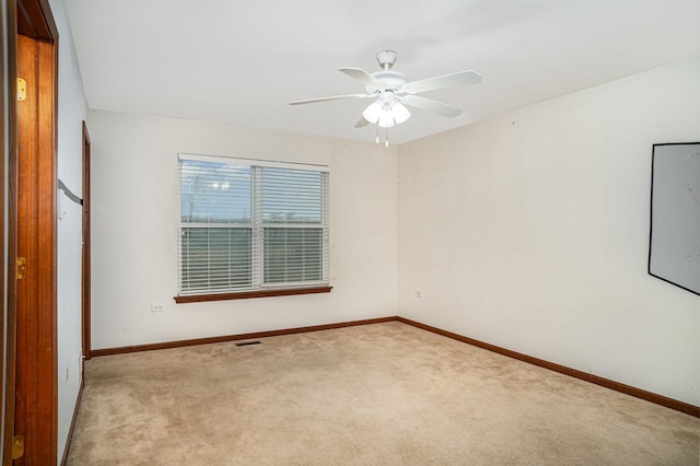 empty room featuring baseboards, ceiling fan, and carpet flooring