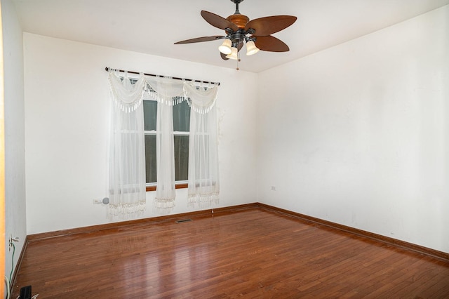 unfurnished room featuring a ceiling fan, baseboards, and wood finished floors
