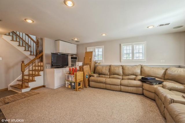 living room with stairs, recessed lighting, visible vents, and light carpet