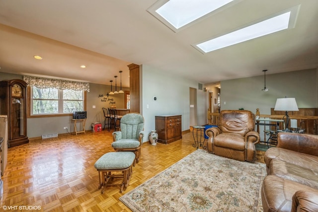 living area featuring recessed lighting, a skylight, visible vents, and baseboards