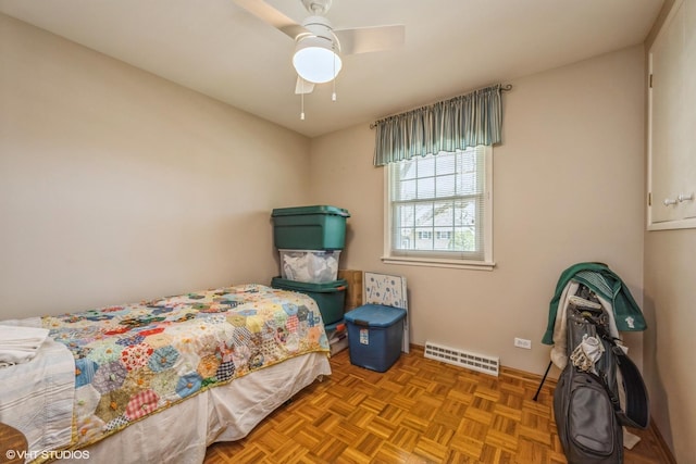 bedroom featuring baseboards, ceiling fan, and visible vents