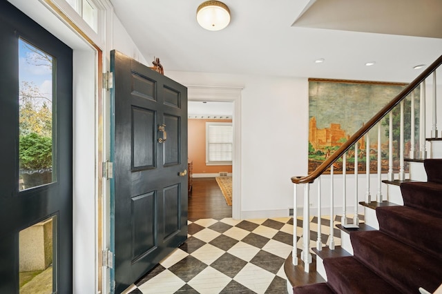 entryway with stairway, baseboards, a healthy amount of sunlight, and recessed lighting
