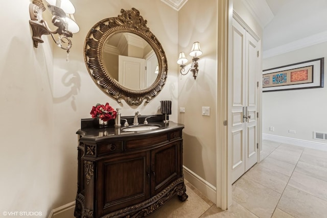 bathroom with vanity, ornamental molding, tile patterned flooring, and baseboards