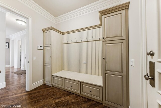 mudroom with crown molding, dark wood-style floors, and baseboards