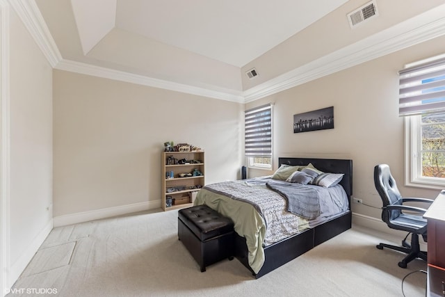carpeted bedroom with baseboards, visible vents, crown molding, and a tray ceiling