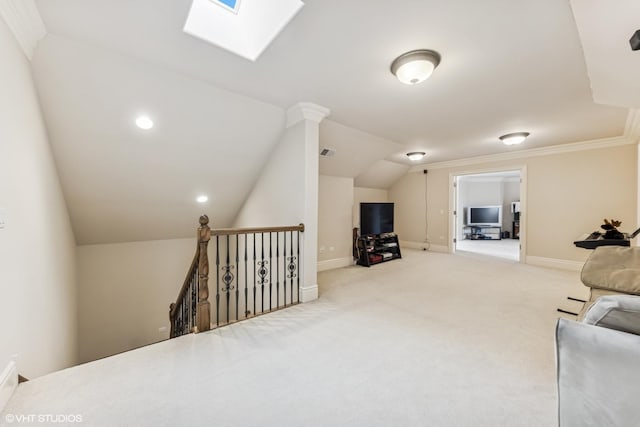 living room with visible vents, light carpet, baseboards, and vaulted ceiling with skylight