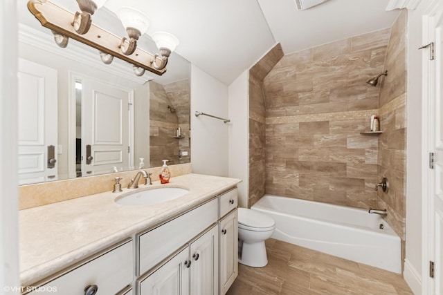 bathroom featuring wood finished floors, vanity, toilet, and shower / bathtub combination
