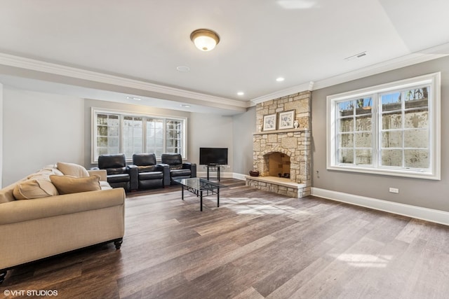 living area with wood finished floors, plenty of natural light, and crown molding