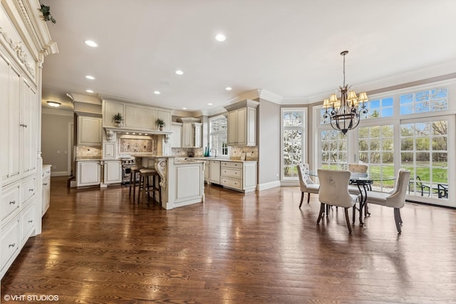 dining area featuring ornamental molding, an inviting chandelier, and dark wood-type flooring