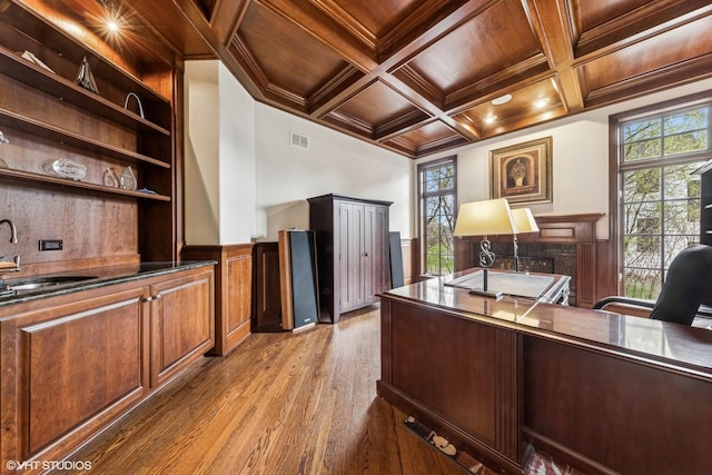 office featuring crown molding, a sink, wooden ceiling, wood finished floors, and wainscoting