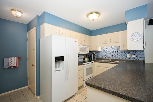 kitchen with white appliances, a sink, dark countertops, decorative backsplash, and light tile patterned floors