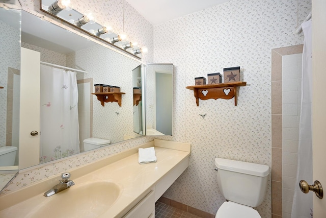 bathroom with toilet, wallpapered walls, a shower with curtain, tile patterned flooring, and vanity