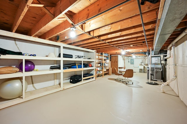 unfinished below grade area with electric panel and heating unit