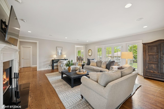 495 Willow Rd, Winnetka, IL 60093 - living area with crown molding, recessed lighting, a lit fireplace, wood finished floors, and baseboards