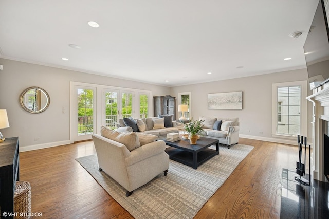 495 Willow Rd, Winnetka, IL 60093 - living area featuring a fireplace with flush hearth, baseboards, crown molding, light wood-style flooring, and recessed lighting