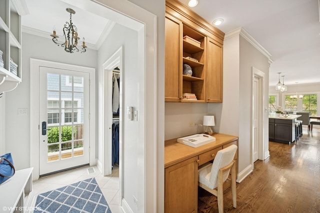 495 Willow Rd, Winnetka, IL 60093 - home office featuring a chandelier, crown molding, built in desk, baseboards, and light wood-style floors