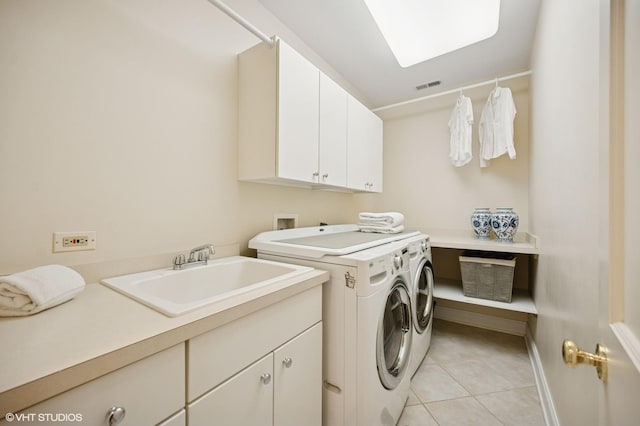 495 Willow Rd, Winnetka, IL 60093 - laundry area with cabinet space, washing machine and dryer, light tile patterned flooring, and baseboards