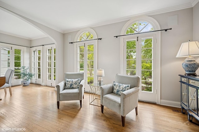 495 Willow Rd, Winnetka, IL 60093 - living area featuring arched walkways, wood-type flooring, ornamental molding, and baseboards