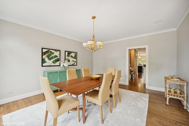 495 Willow Rd, Winnetka, IL 60093 - dining space with crown molding, a chandelier, wood finished floors, and baseboards