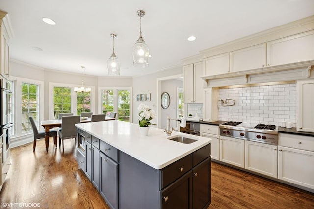 495 Willow Rd, Winnetka, IL 60093 - kitchen featuring stainless steel appliances, a sink, decorative backsplash, a chandelier, and ornamental molding