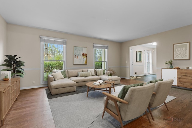 living room featuring wood finished floors and baseboards