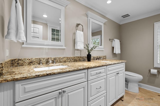 bathroom with double vanity, toilet, a sink, crown molding, and visible vents