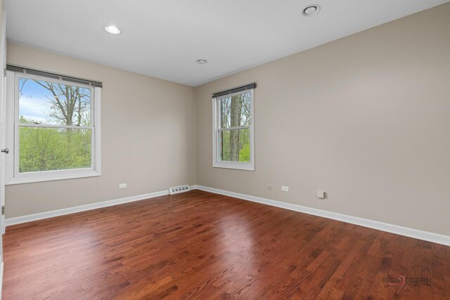 spare room featuring visible vents, wood finished floors, baseboards, and recessed lighting