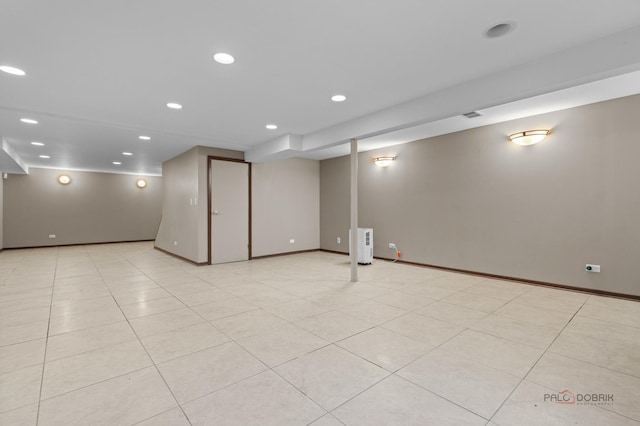 finished basement with baseboards and recessed lighting