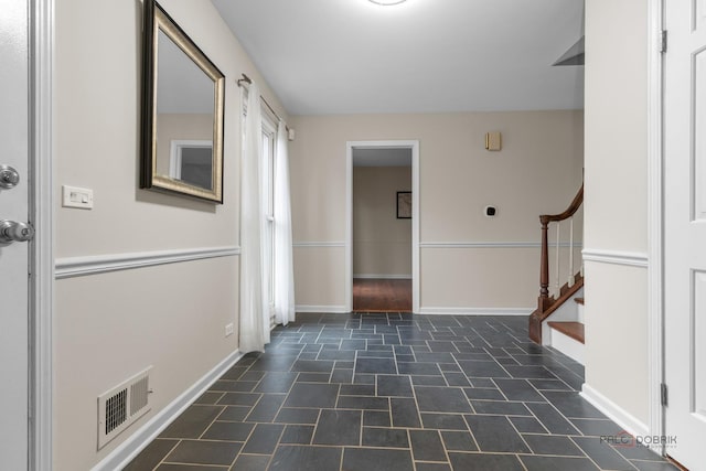 entryway with visible vents, stairs, and baseboards