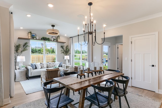 dining room with recessed lighting, vaulted ceiling, a chandelier, and light wood-style floors