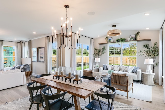 dining room with an inviting chandelier, light wood-style floors, and baseboards