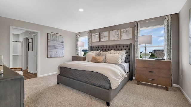 bedroom with recessed lighting, light carpet, and baseboards