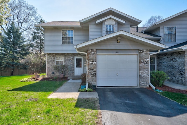view of front facade with brick siding, a garage, driveway, and a front yard