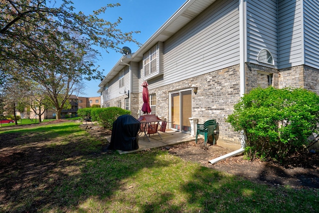 exterior space featuring a lawn and a patio