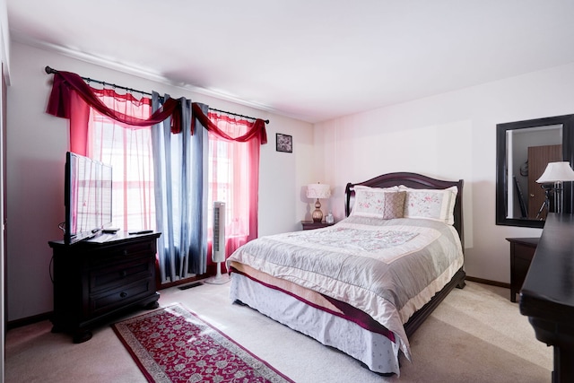 carpeted bedroom with visible vents and baseboards