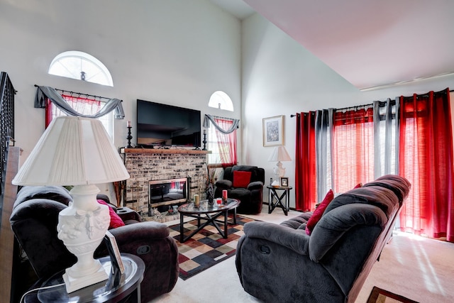 living room featuring carpet floors, high vaulted ceiling, plenty of natural light, and a fireplace