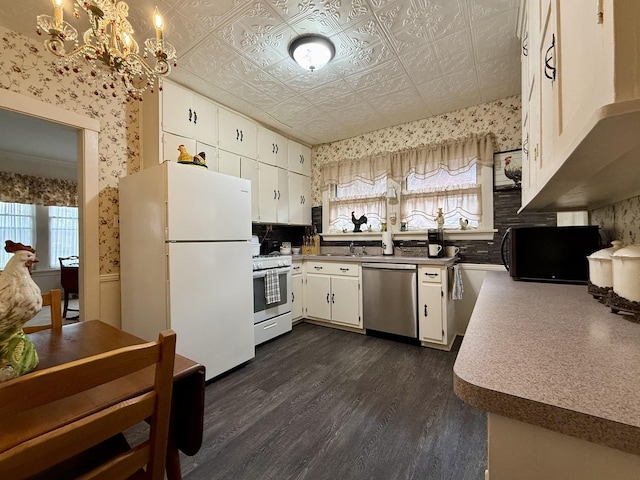 kitchen with a healthy amount of sunlight, wallpapered walls, and white appliances