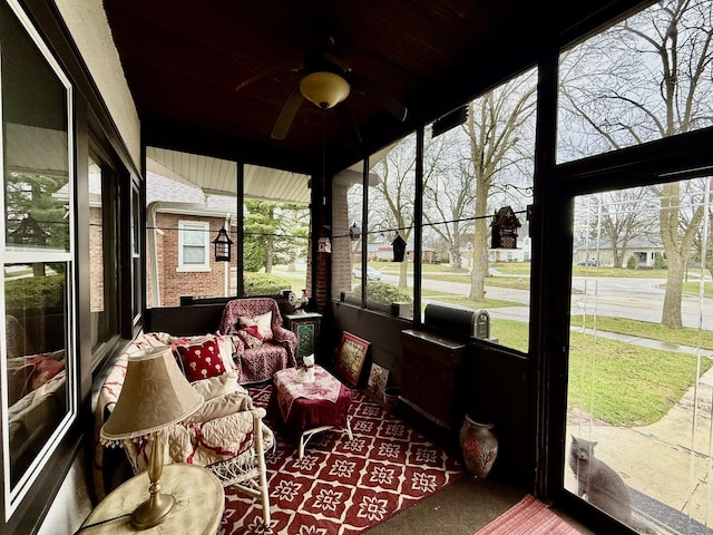 sunroom / solarium featuring ceiling fan