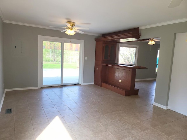 empty room featuring baseboards, ceiling fan, and ornamental molding