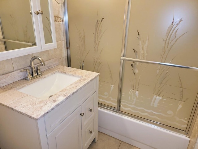 bathroom with vanity, backsplash, and shower / bath combination with glass door