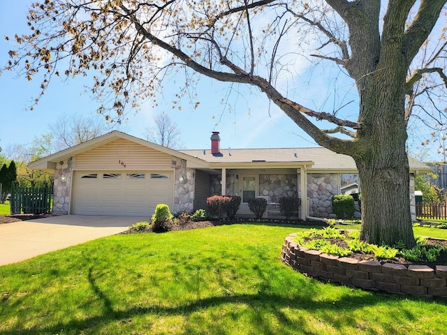 ranch-style home featuring an attached garage, driveway, stone siding, and a front lawn