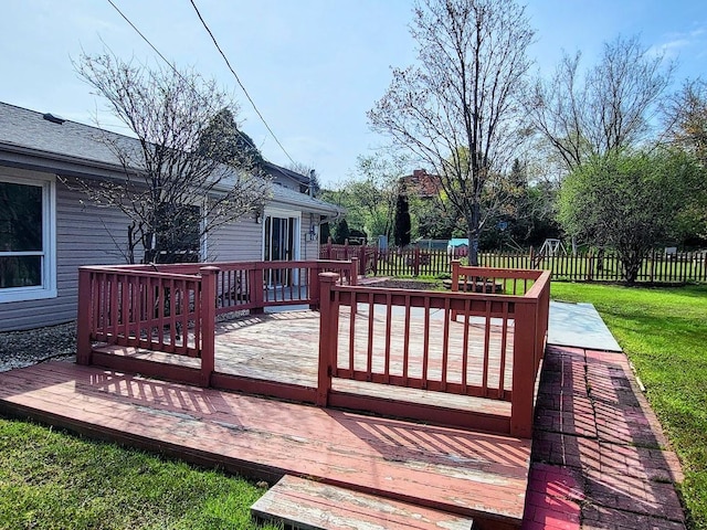 deck featuring a yard and a fenced backyard