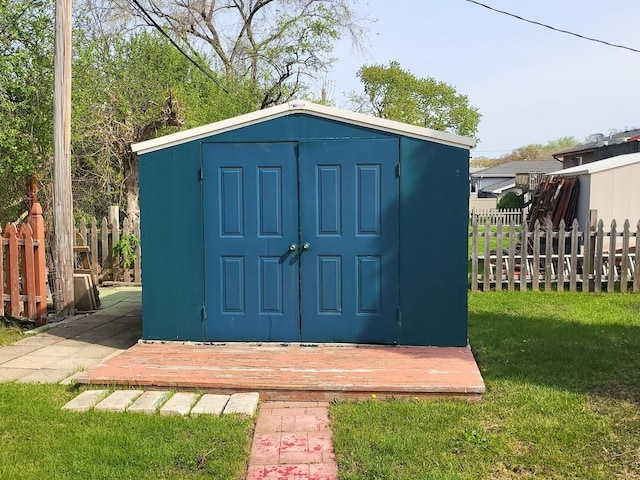 view of shed featuring fence