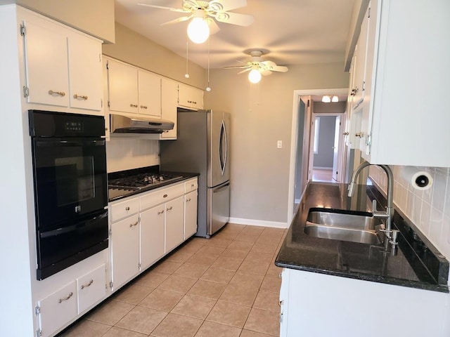 kitchen featuring freestanding refrigerator, oven, ceiling fan, a sink, and a warming drawer