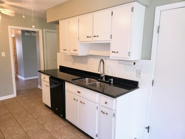 kitchen featuring backsplash, light tile patterned floors, a sink, and dishwasher