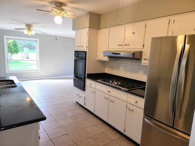 kitchen featuring light tile patterned flooring, under cabinet range hood, a ceiling fan, appliances with stainless steel finishes, and a warming drawer