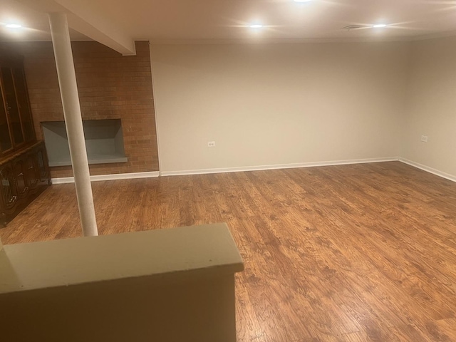 finished basement with baseboards and wood finished floors