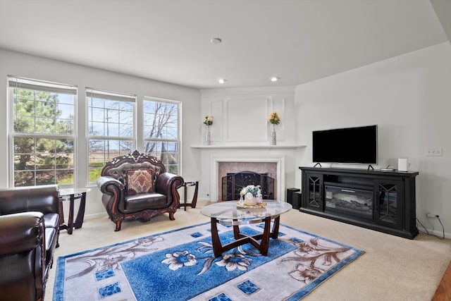 living area with baseboards, recessed lighting, a high end fireplace, and carpet floors
