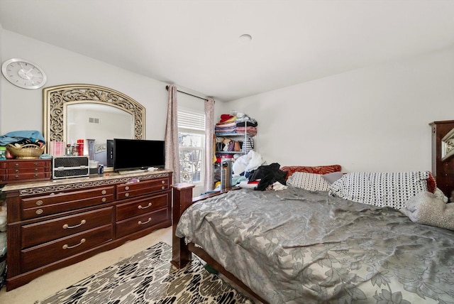 bedroom featuring light colored carpet