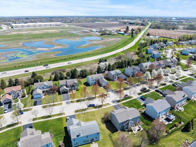 drone / aerial view with a water view and a residential view